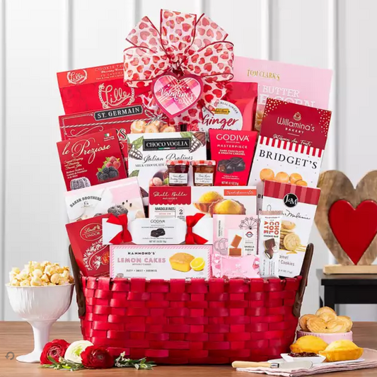 Gift basket with various products including chocolate and snacks on a wooden table.